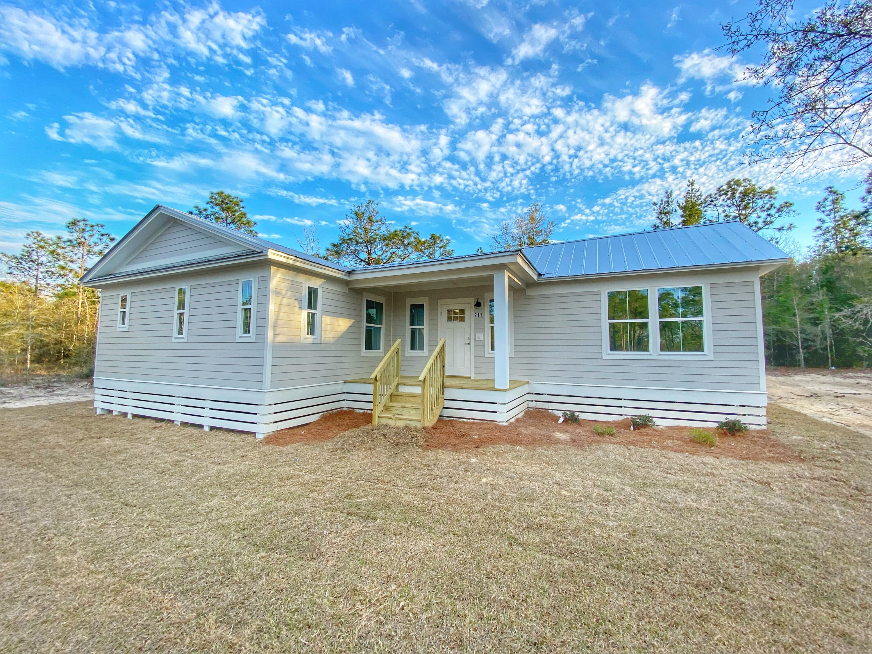 211 West Renoir Road DeFuniak Springs, FL 32433 - Photo 6 of 19 a house with trees in the background