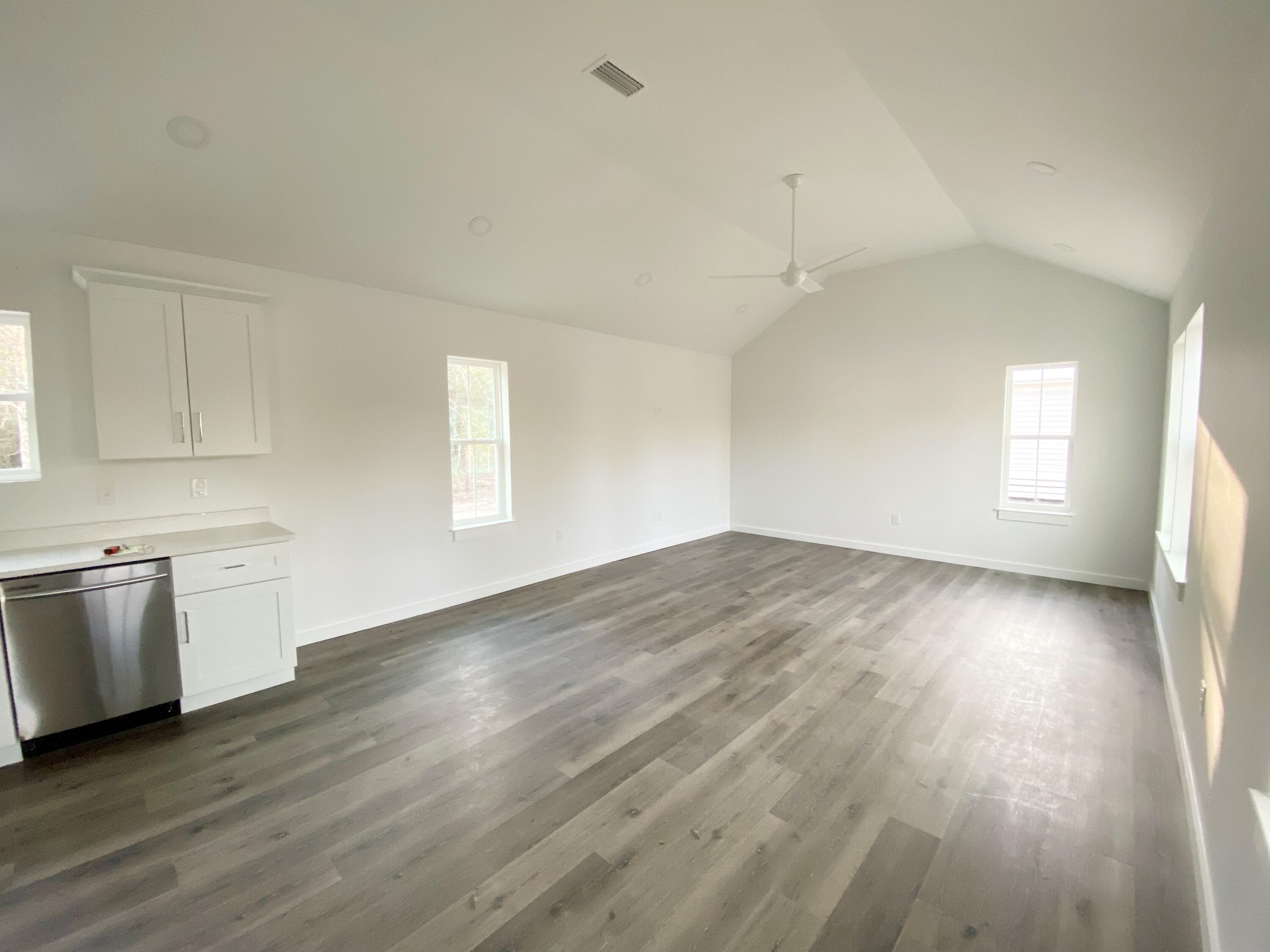 211 West Renoir Road DeFuniak Springs, FL 32433 - Photo 7 of 19 an empty room with wooden floor and windows