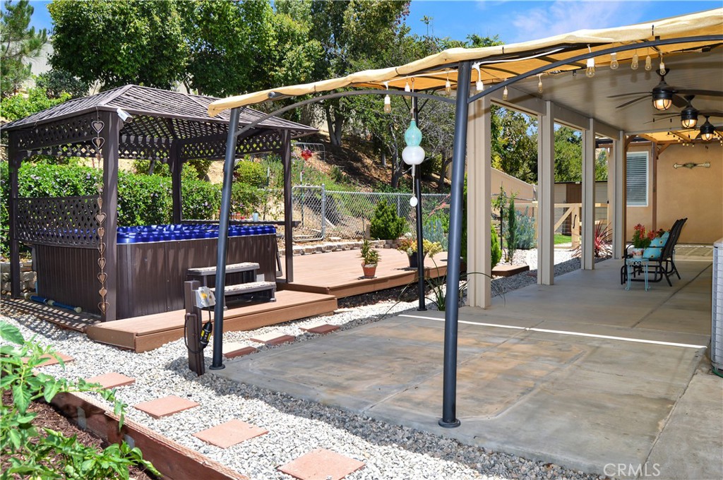 166 Fox Lane Calimesa, CA 92320 - Photo 60 of 76 Approx. 1/4-Acre Lot with Above-Ground Spa, Gazebo, Decking, Covered Patio with 3 Fans and Extra Shaded Sections, Dog Run, 3 Sheds, Fruit Trees, Grape Vines, Vegetable Garden, Bed of Irises Almost Ready to Bloom, and Gated RV Parking