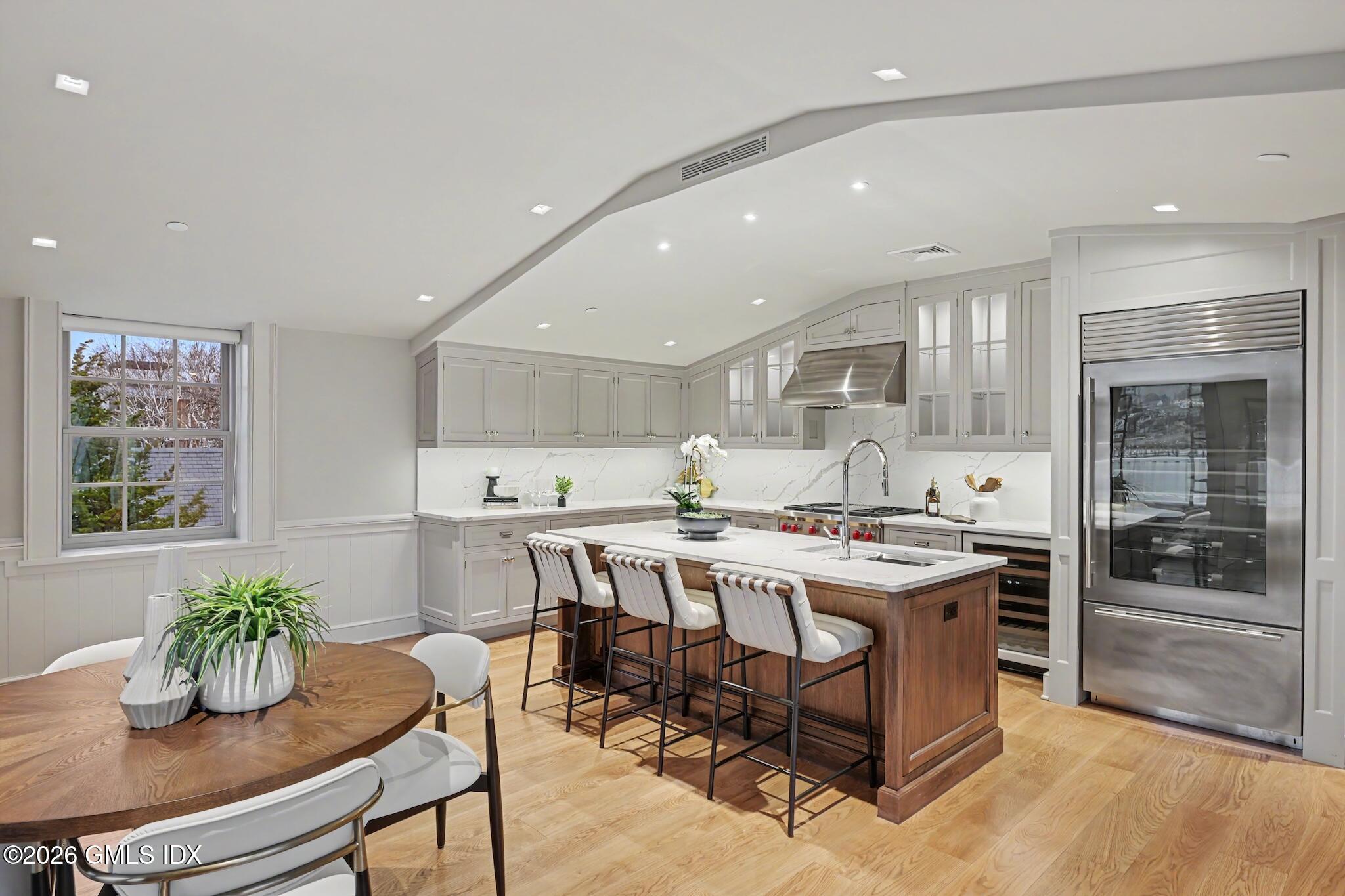 702 Steamboat Road, Unit 6 Greenwich, CT 06830 - Photo 13 of 45 a kitchen with a table and chairs in it
