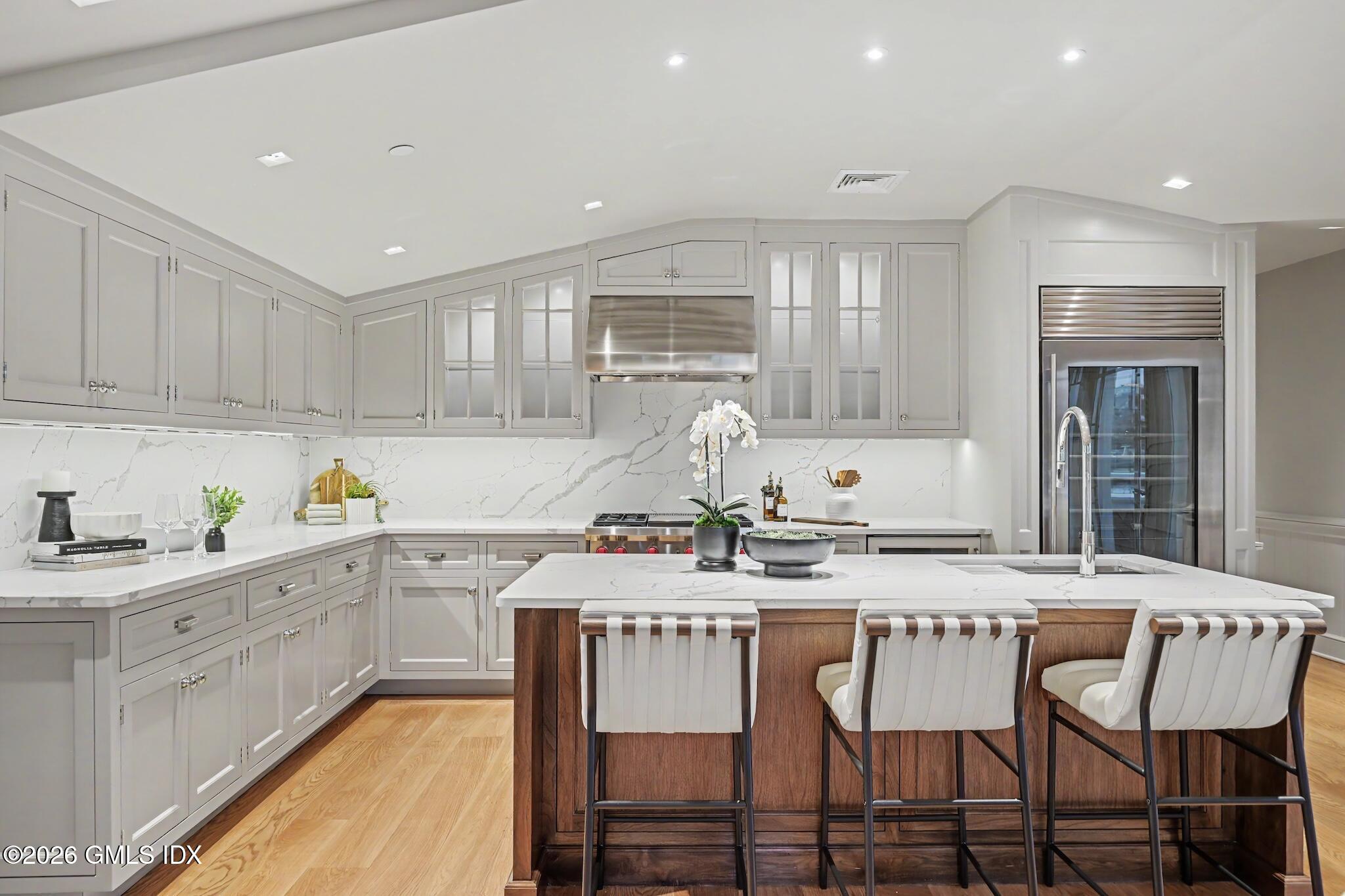 702 Steamboat Road, Unit 6 Greenwich, CT 06830 - Photo 14 of 45 a kitchen with a dining table chairs and cabinets