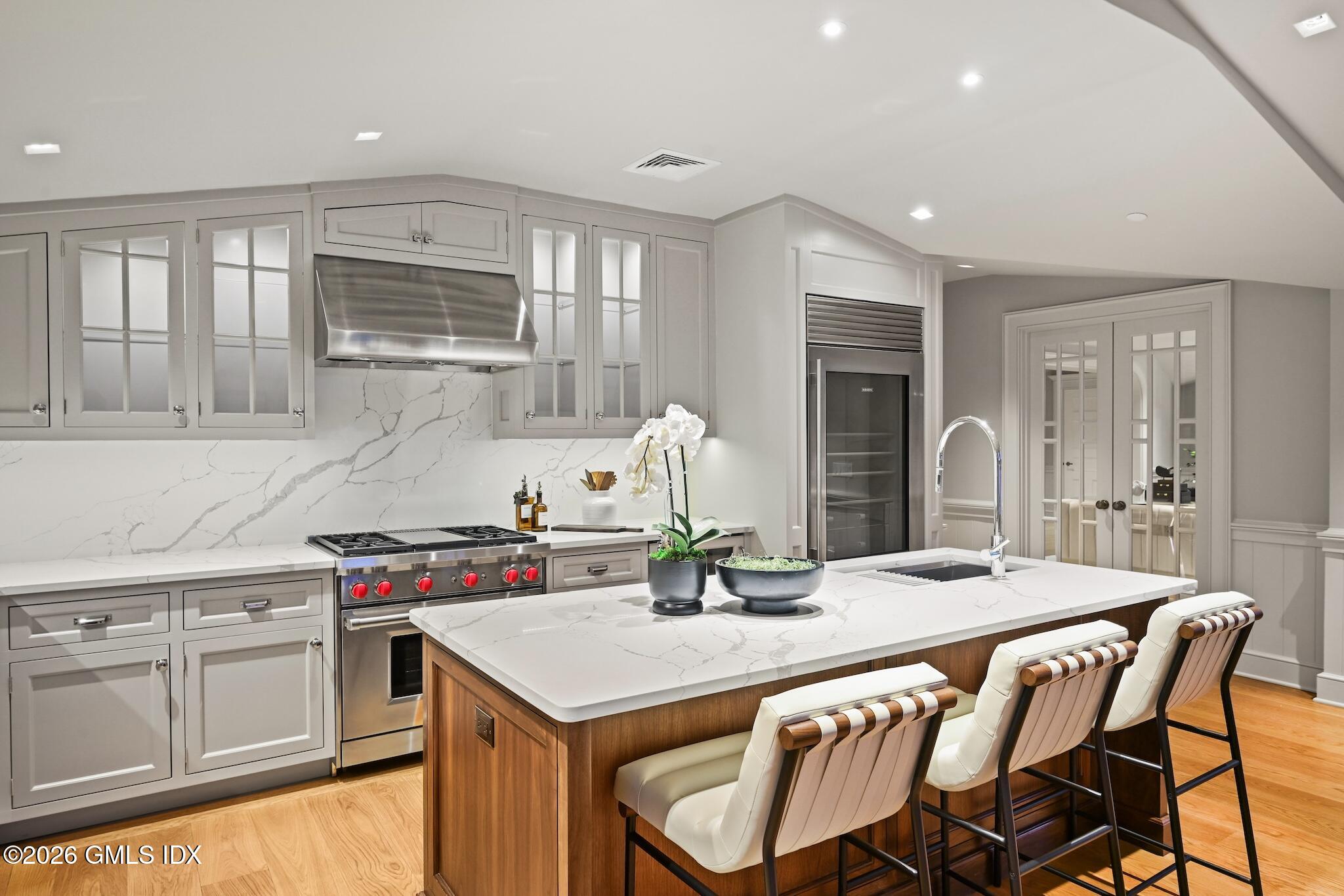 702 Steamboat Road, Unit 6 Greenwich, CT 06830 - Photo 17 of 45 a kitchen with kitchen island granite countertop a sink and cabinets