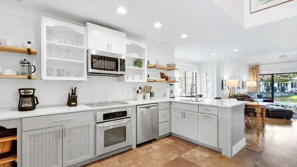 a kitchen with stainless steel appliances granite countertop a sink and stove top oven