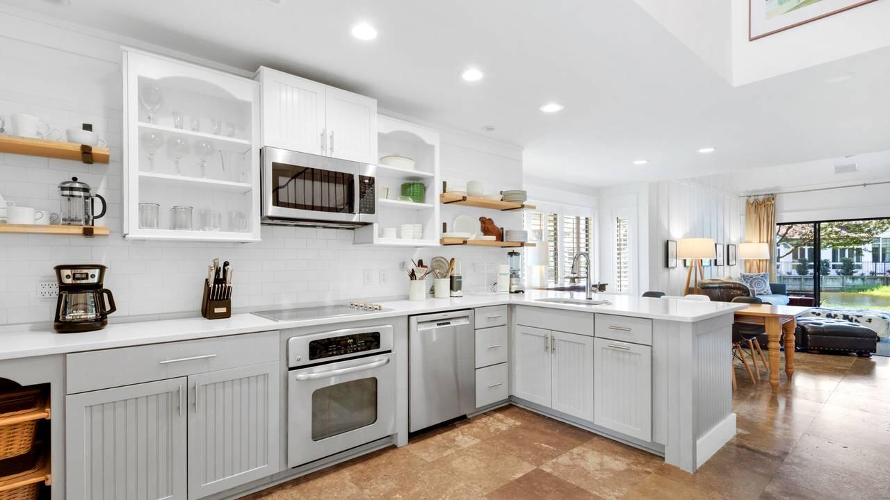 5054 Beachwalk Way Miramar Beach, FL 32550 - Photo 12 of 28 a kitchen with stainless steel appliances granite countertop a sink and stove top oven