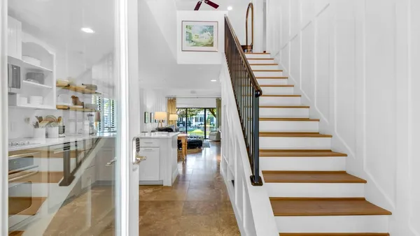 a view of entryway and hall with wooden floor
