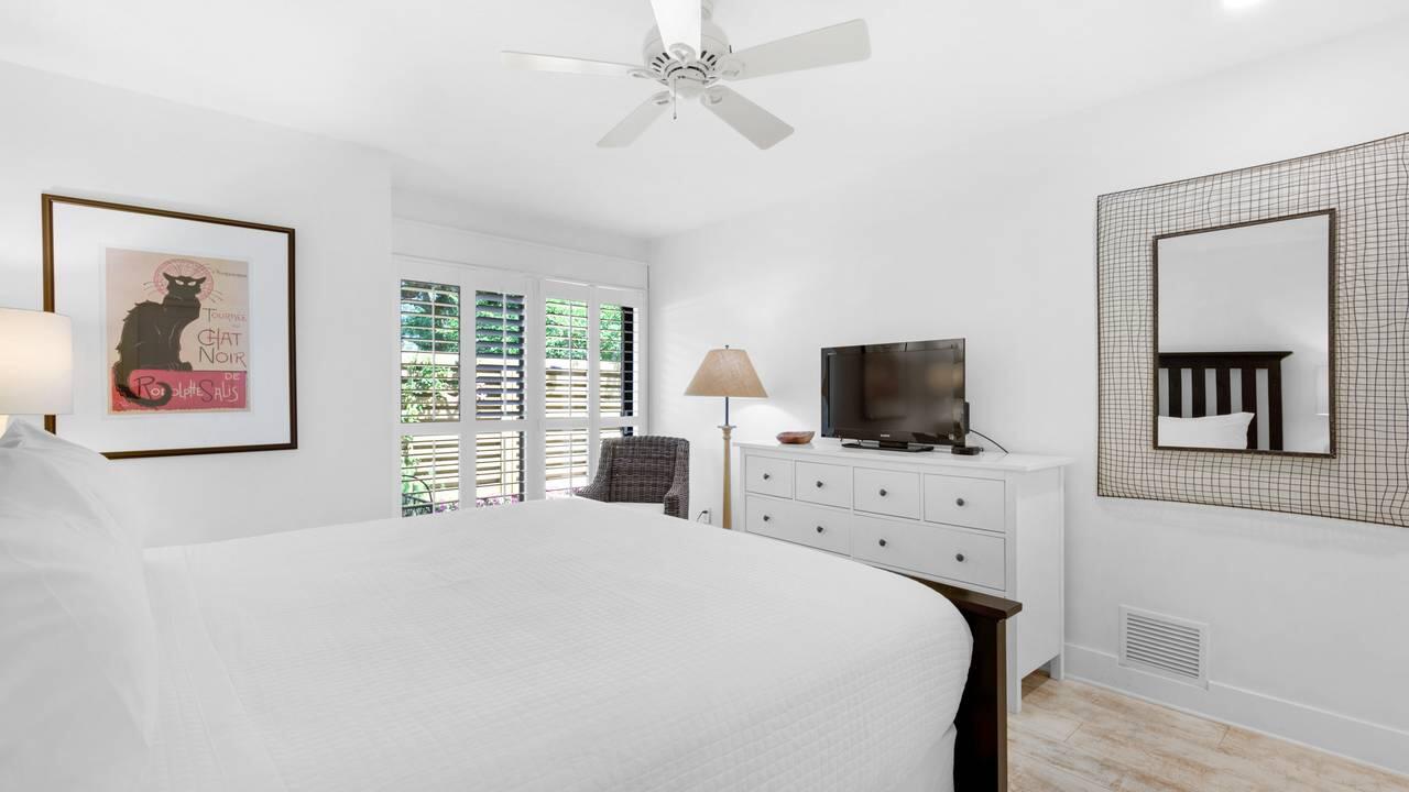 5054 Beachwalk Way Miramar Beach, FL 32550 - Photo 15 of 28 a bedroom with a bed and a flat screen tv