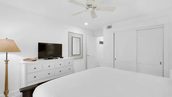 a hotel room with a bed and a flat screen tv