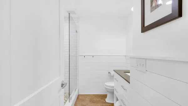 a bathroom with a toilet and a shower