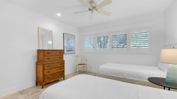 a bedroom with a bed and ceiling fan