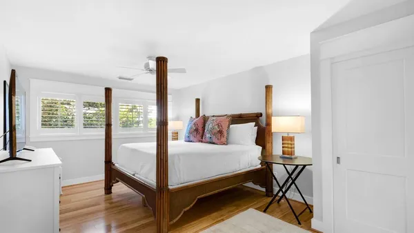 a bedroom with a bed and a night stand