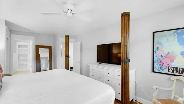 a bedroom with a bed and a flat screen tv