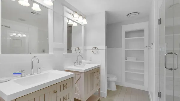 a bathroom with a double vanity sink mirror and