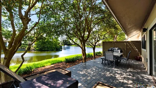 a view of backyard with swimming pool and sitting area