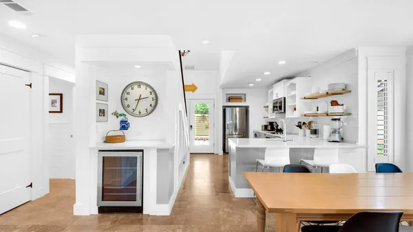 a living room with fireplace furniture and a clock