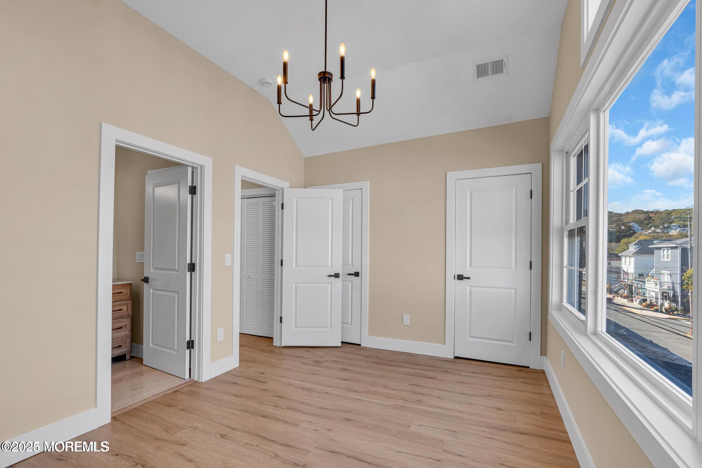 39 Sea Drift Avenue Highlands, NJ 07732 - Photo 11 of 12 a view of a hallway with wooden floor and chandelier