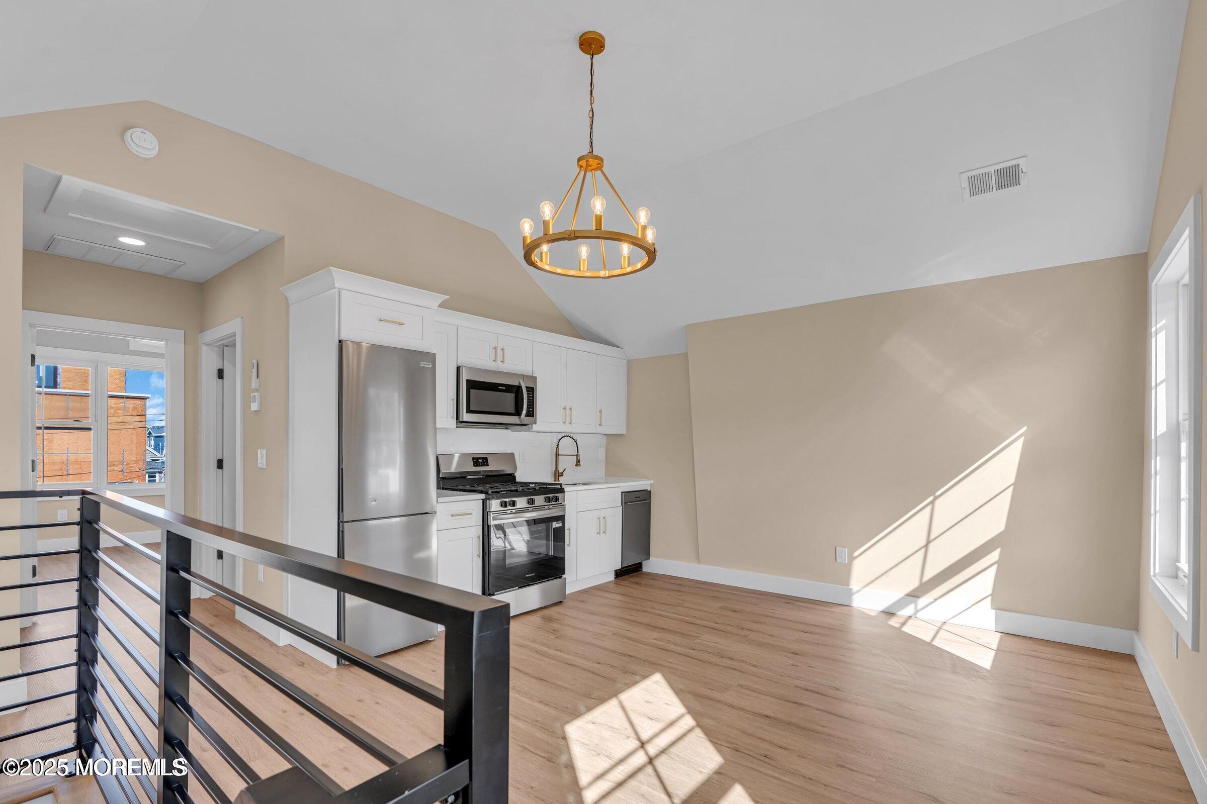 39 Sea Drift Avenue Highlands, NJ 07732 - Photo 4 of 12 a kitchen with stainless steel appliances granite countertop a refrigerator a stove a sink dishwasher and a oven with wooden floor