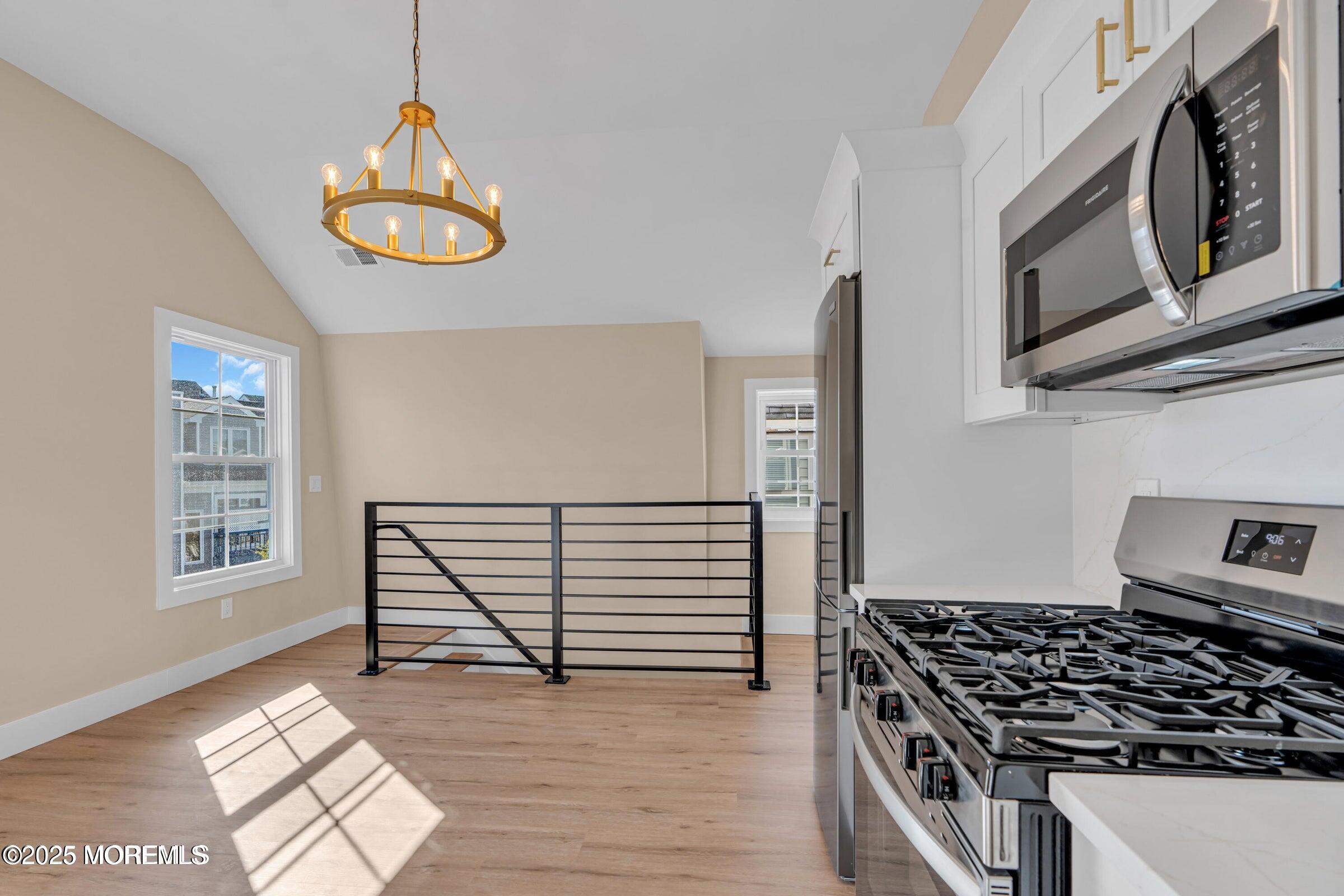 39 Sea Drift Avenue Highlands, NJ 07732 - Photo 7 of 12 a kitchen with stainless steel appliances granite countertop a stove and a microwave
