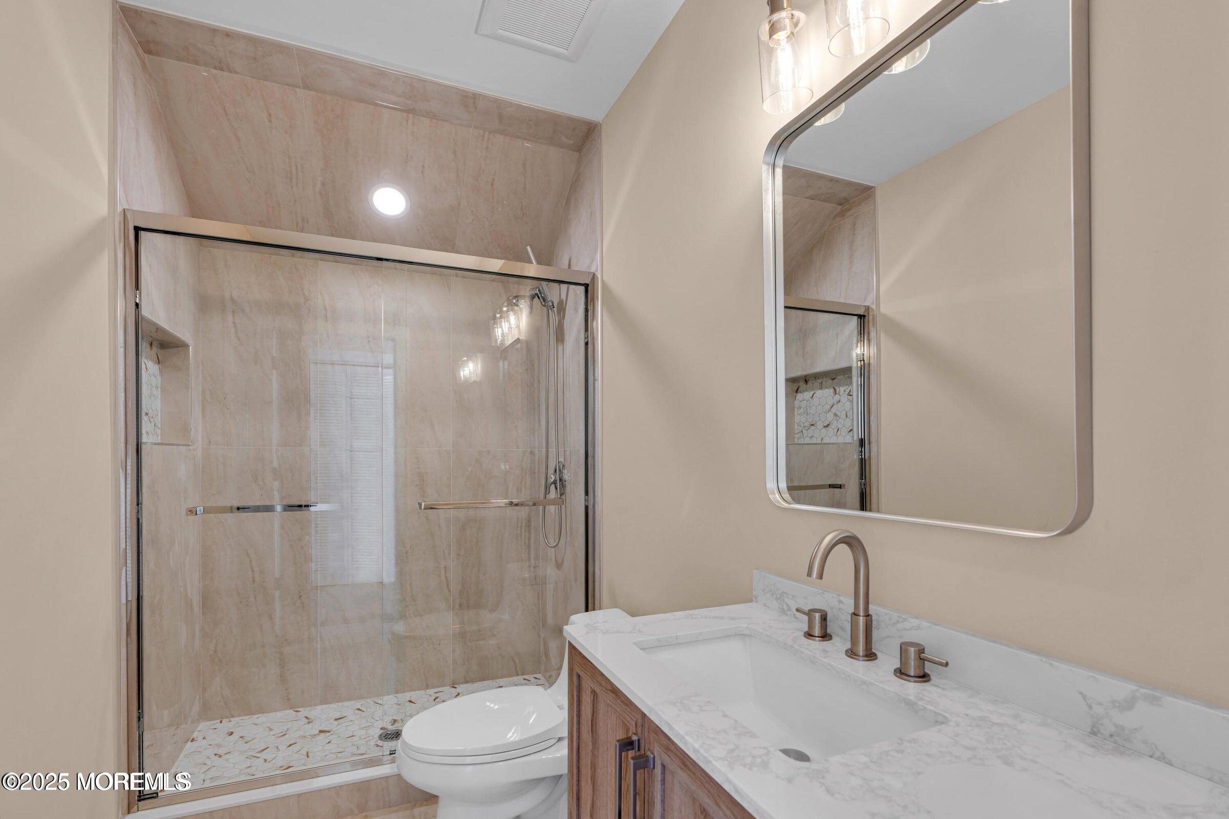 39 Sea Drift Avenue Highlands, NJ 07732 - Photo 8 of 12 a bathroom with a sink toilet and shower