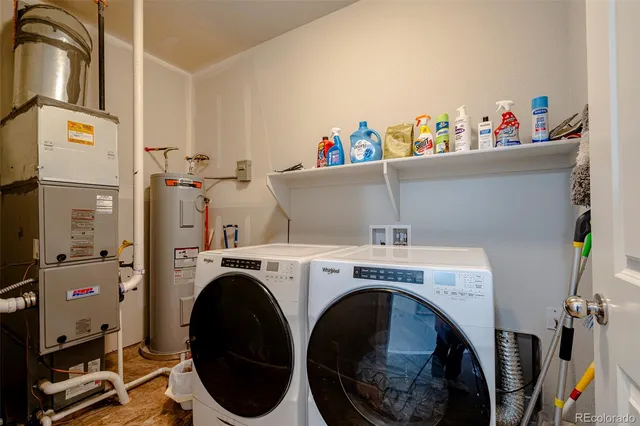 a utility room with dryer washer and shoe rack