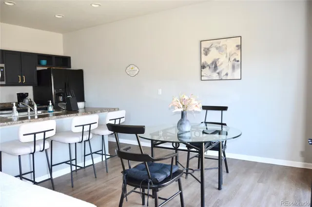 a view of a dining room with furniture and wooden floor
