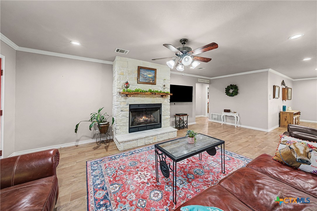 1601 Sunset Circle Cameron, TX 76520 - Photo 9 of 40 a living room with furniture a fireplace and a flat screen tv