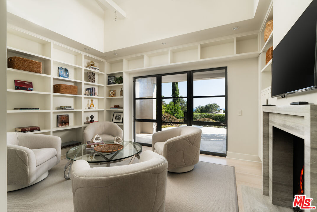 796 Hot Springs Road Montecito, CA 93108 - Photo 12 of 47 a living room with furniture a fireplace and a flat screen tv