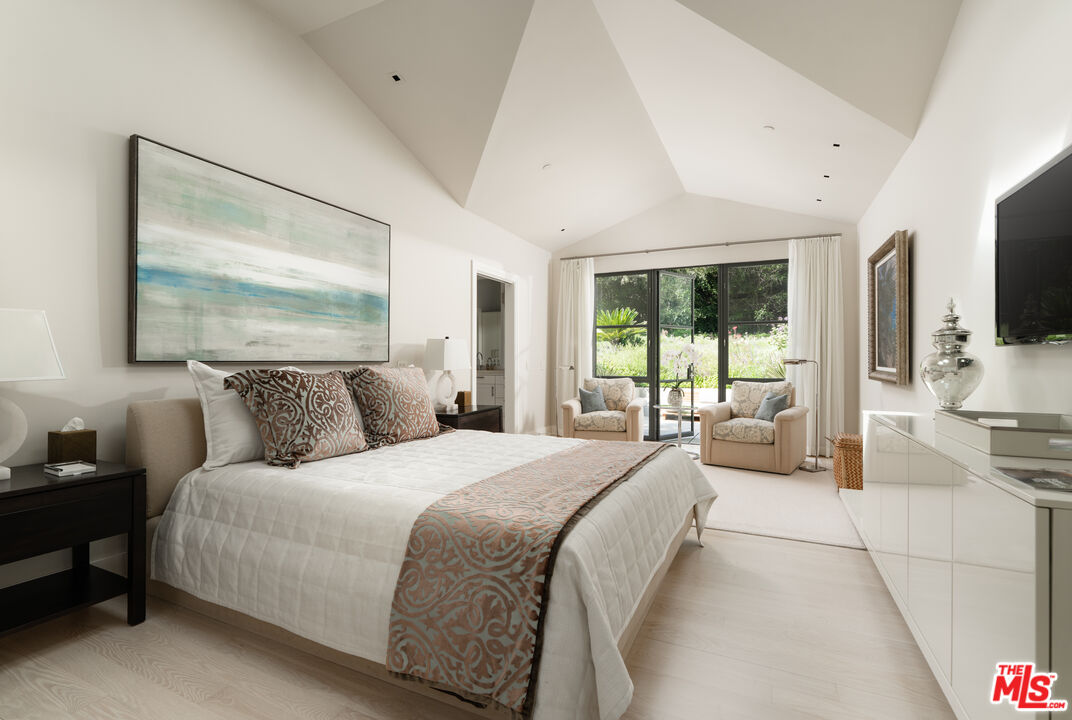 796 Hot Springs Road Montecito, CA 93108 - Photo 24 of 47 a bedroom with a large bed and a flat tv screen on dresser