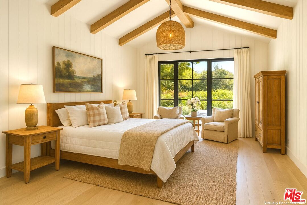 796 Hot Springs Road Montecito, CA 93108 - Photo 25 of 47 a bedroom with a bed and a chandelier