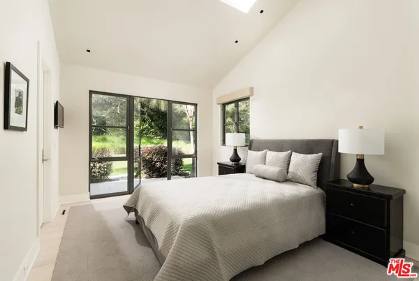a bathroom with a granite countertop sink and a large mirror