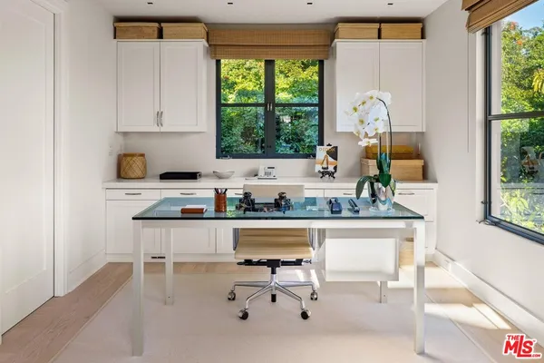 a storage room with cabinets washer and dryer