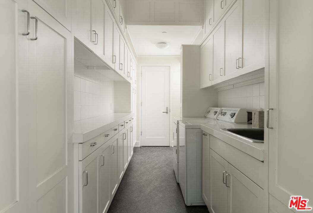 796 Hot Springs Road Montecito, CA 93108 - Photo 32 of 47 a storage room with cabinets washer and dryer