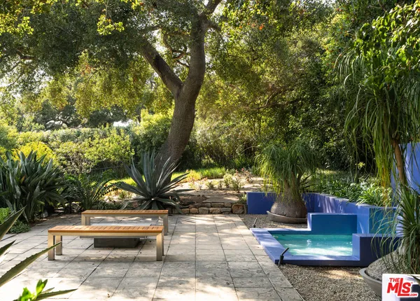 a view of a house with a yard and potted plants