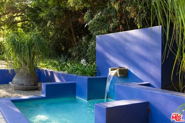 a view of a house with backyard sitting area and swimming pool