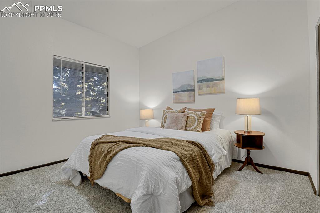 1006 Fontmore Road, Unit C Colorado Springs, CO 80904 - Photo 13 of 33 a bedroom with a bed and a lamp