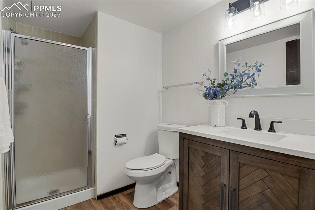 1006 Fontmore Road, Unit C Colorado Springs, CO 80904 - Photo 15 of 33 a bathroom with a granite countertop sink toilet and shower