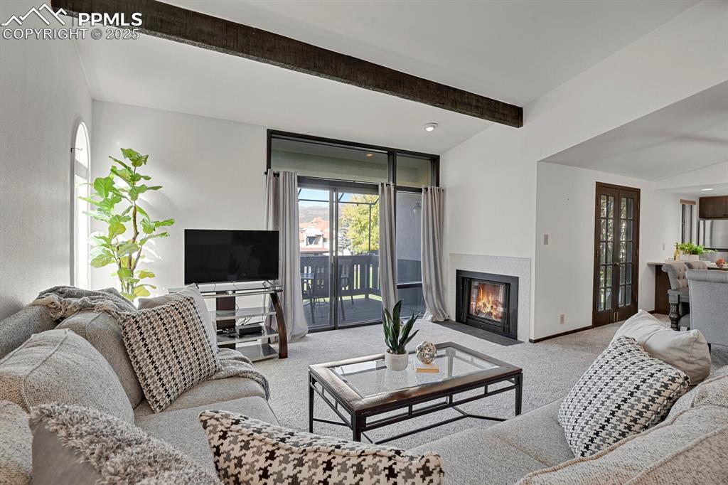 1006 Fontmore Road, Unit C Colorado Springs, CO 80904 - Photo 2 of 33 a living room with furniture a fireplace and a flat screen tv