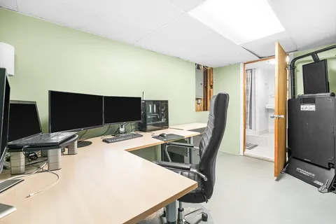 a dining room with a table chairs and a flat screen tv
