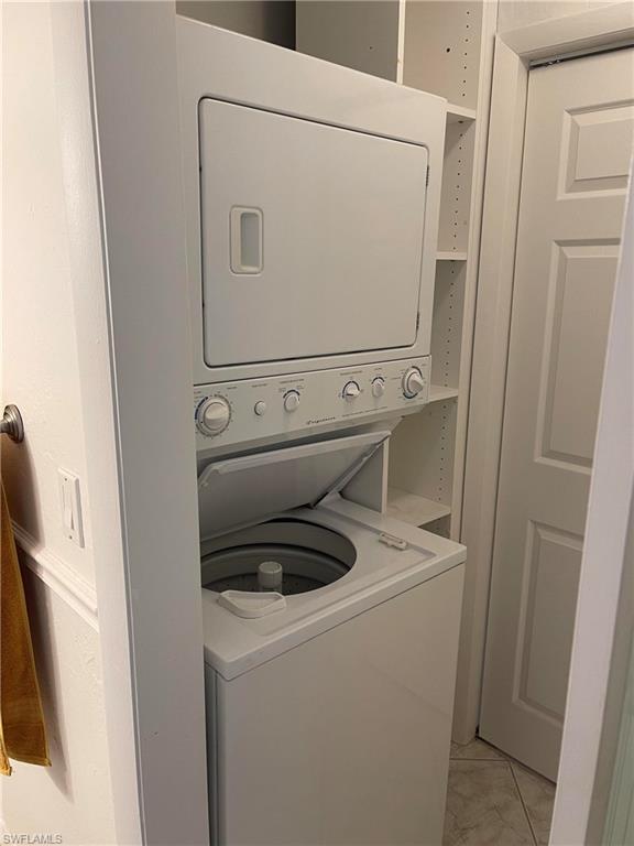 1095 Pine Isle Lane, Unit 1095 Naples, FL 34112 - Photo 7 of 10 a utility room with dryer and washer