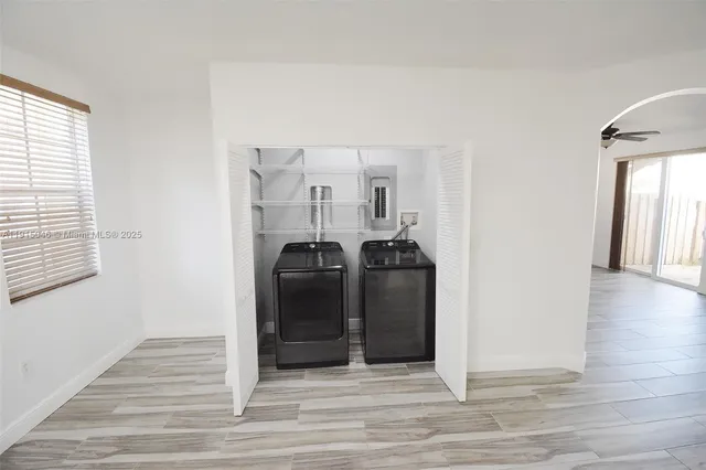 a view of a closet area with wooden floor