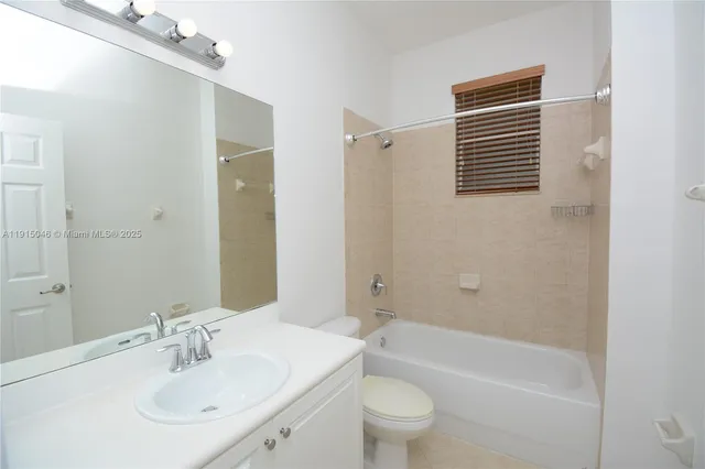 an empty room with a window and a ceiling fan