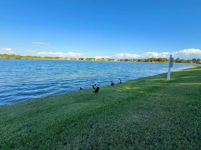 an aerial view of a house with a yard and swimming pool