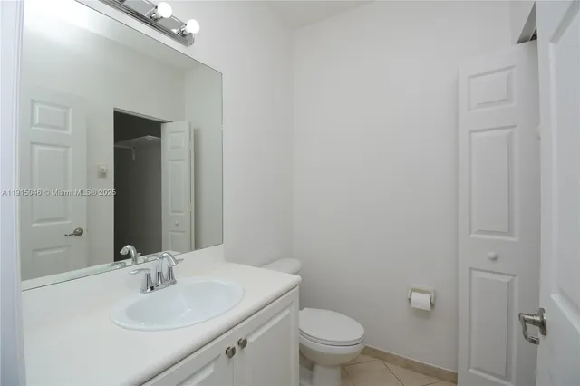 a bathroom with a sink toilet and vanity