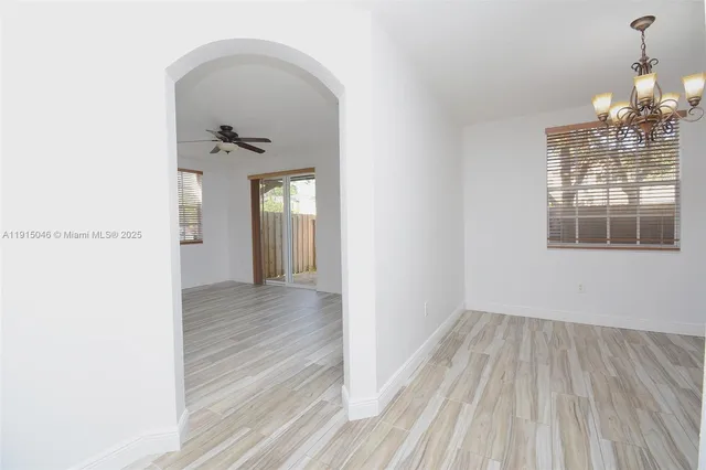 a view of a room with wooden floor staircase and a living room