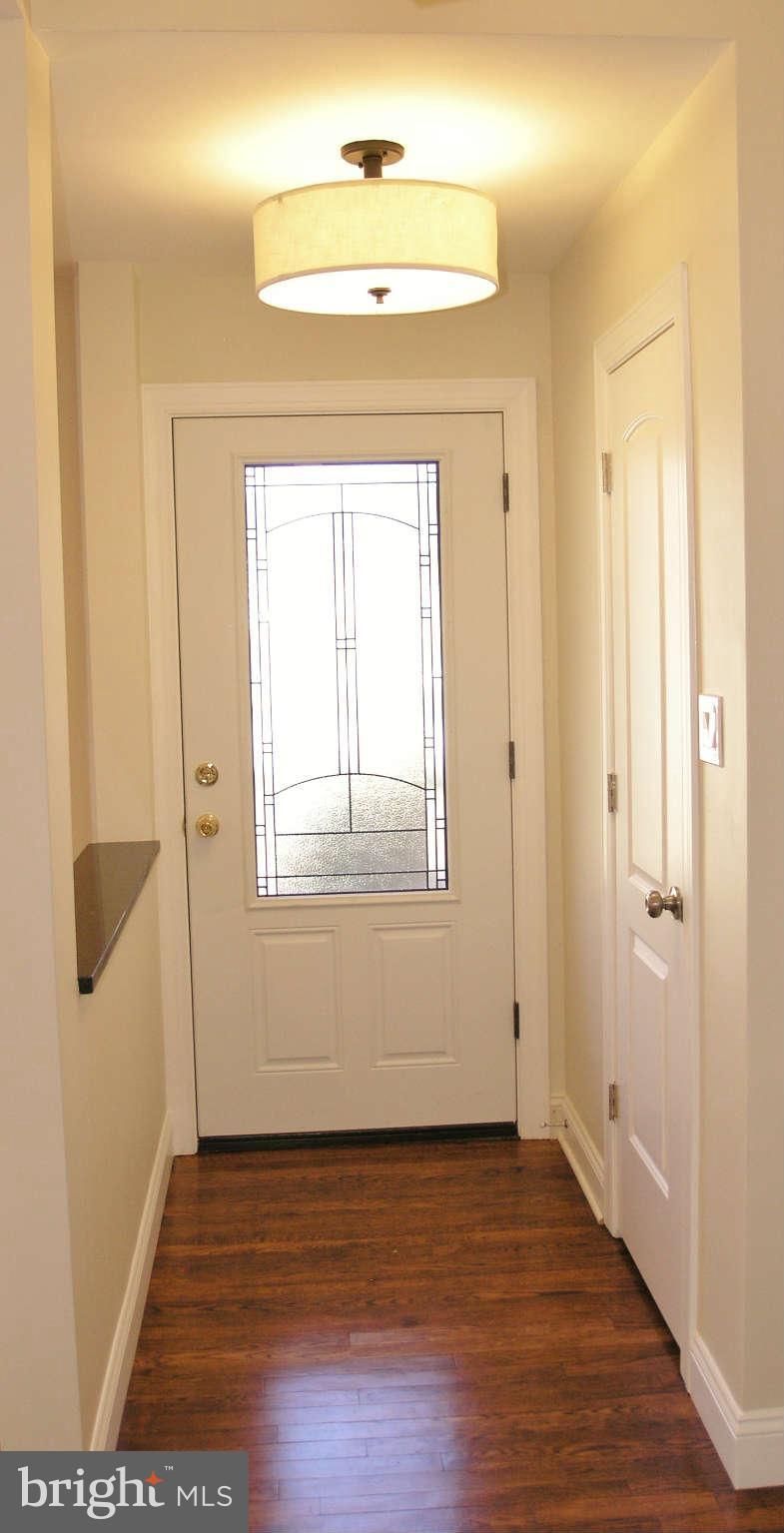 2011 Cascade Road Silver Spring, MD 20902 - Photo 11 of 24 a view of an empty room with wooden floor and a window