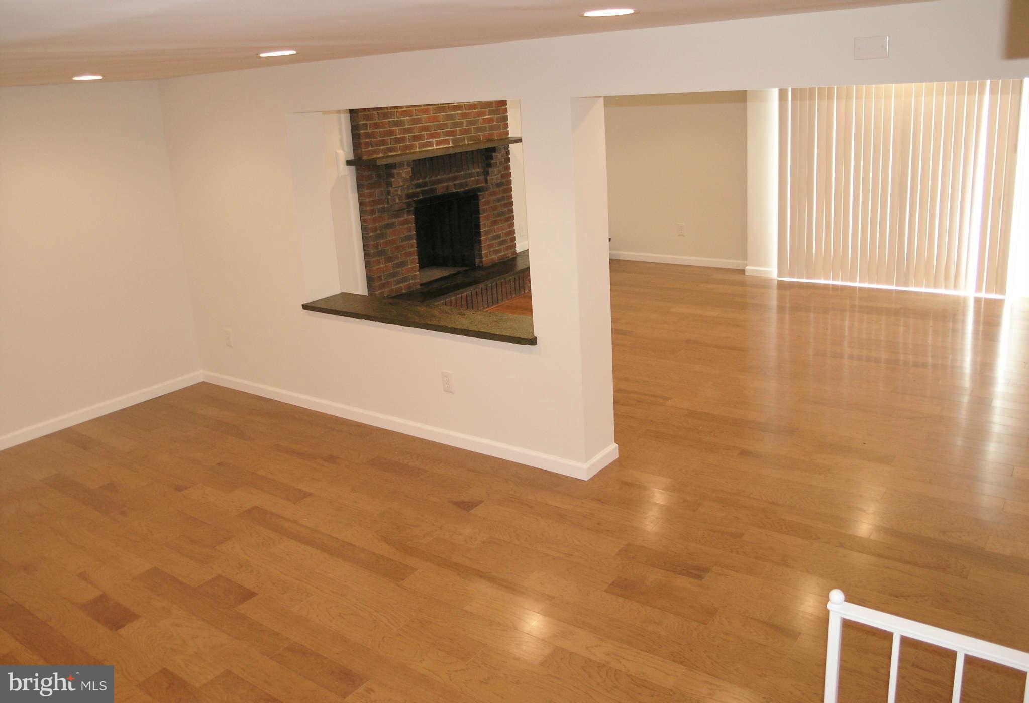 2011 Cascade Road Silver Spring, MD 20902 - Photo 13 of 24 a view of a livingroom with an empty space and a fireplace