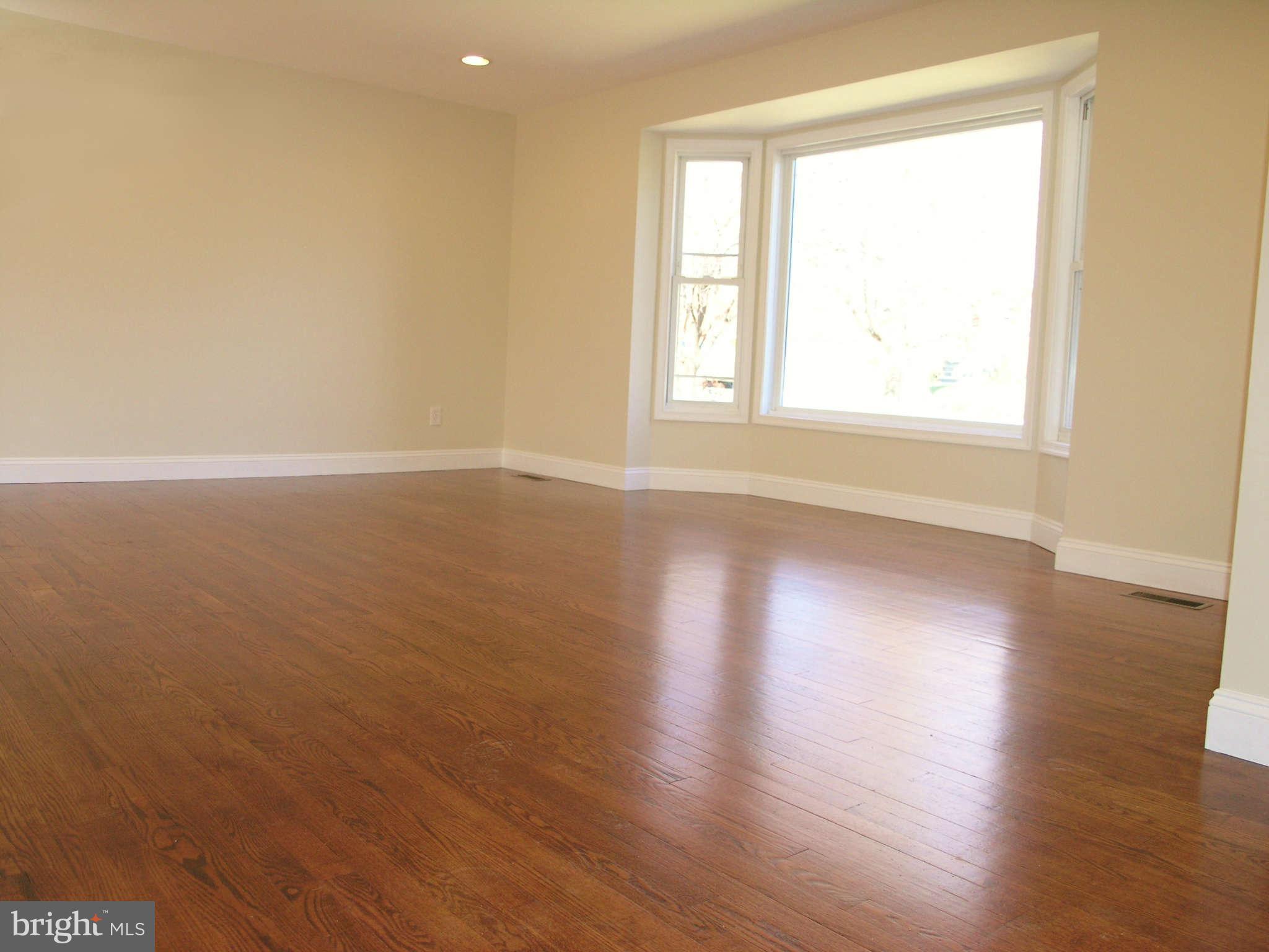 2011 Cascade Road Silver Spring, MD 20902 - Photo 3 of 24 a view of an empty room with wooden floor and a window