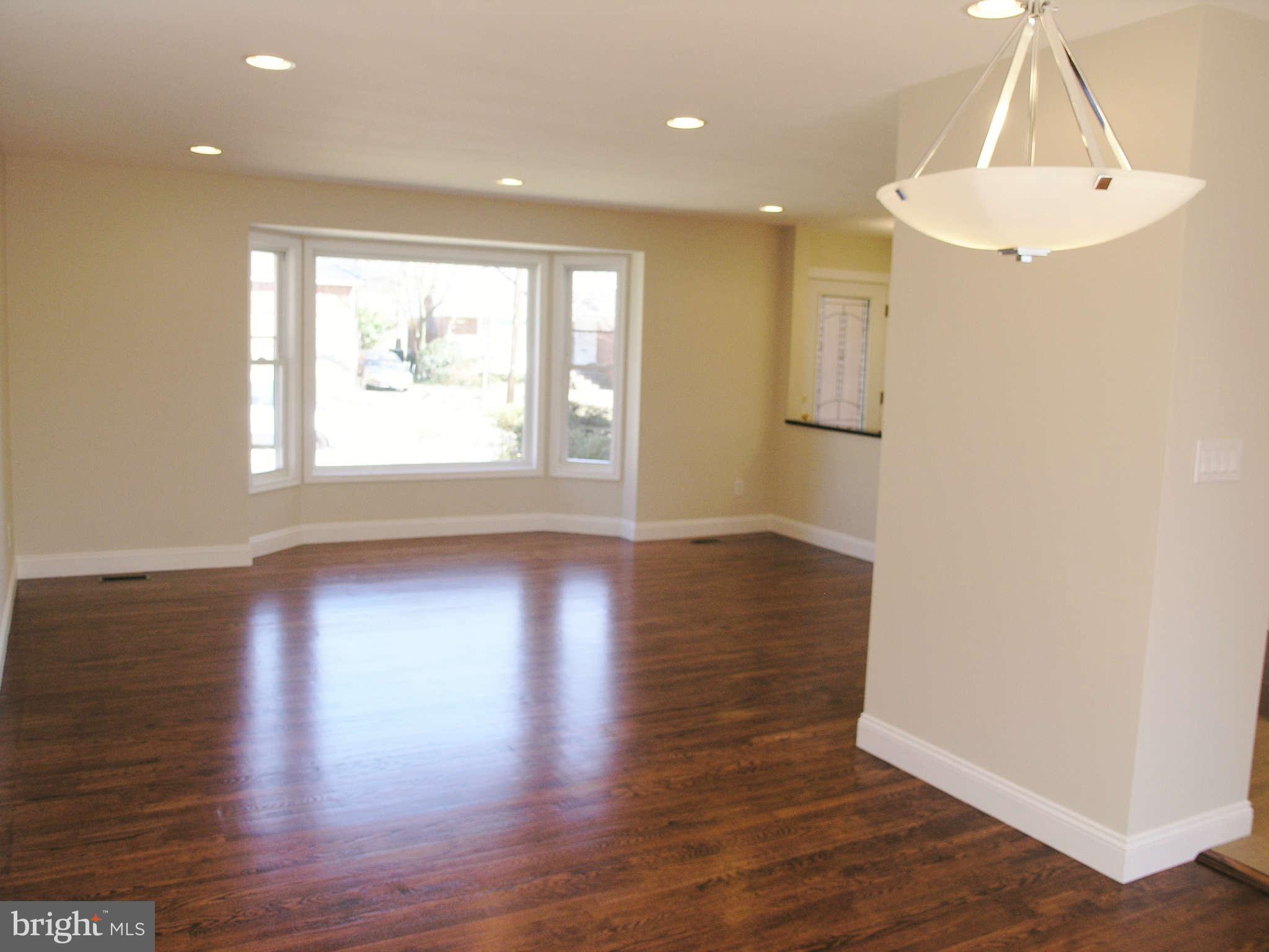 2011 Cascade Road Silver Spring, MD 20902 - Photo 5 of 24 an empty room with wooden floor and windows