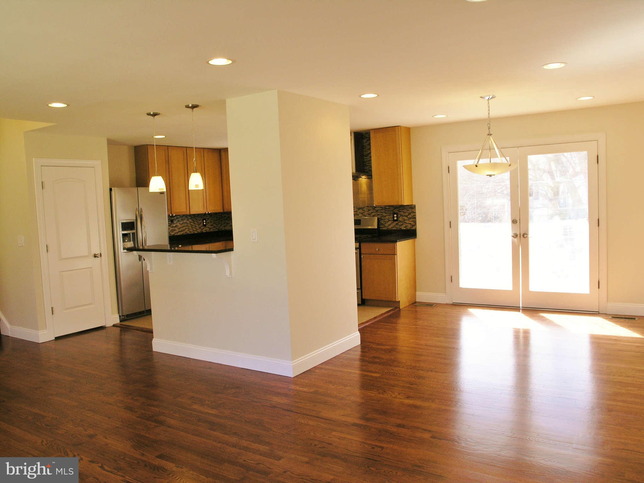 2011 Cascade Road Silver Spring, MD 20902 - Photo 6 of 24 a view of a kitchen with a refrigerator wooden floor and a window