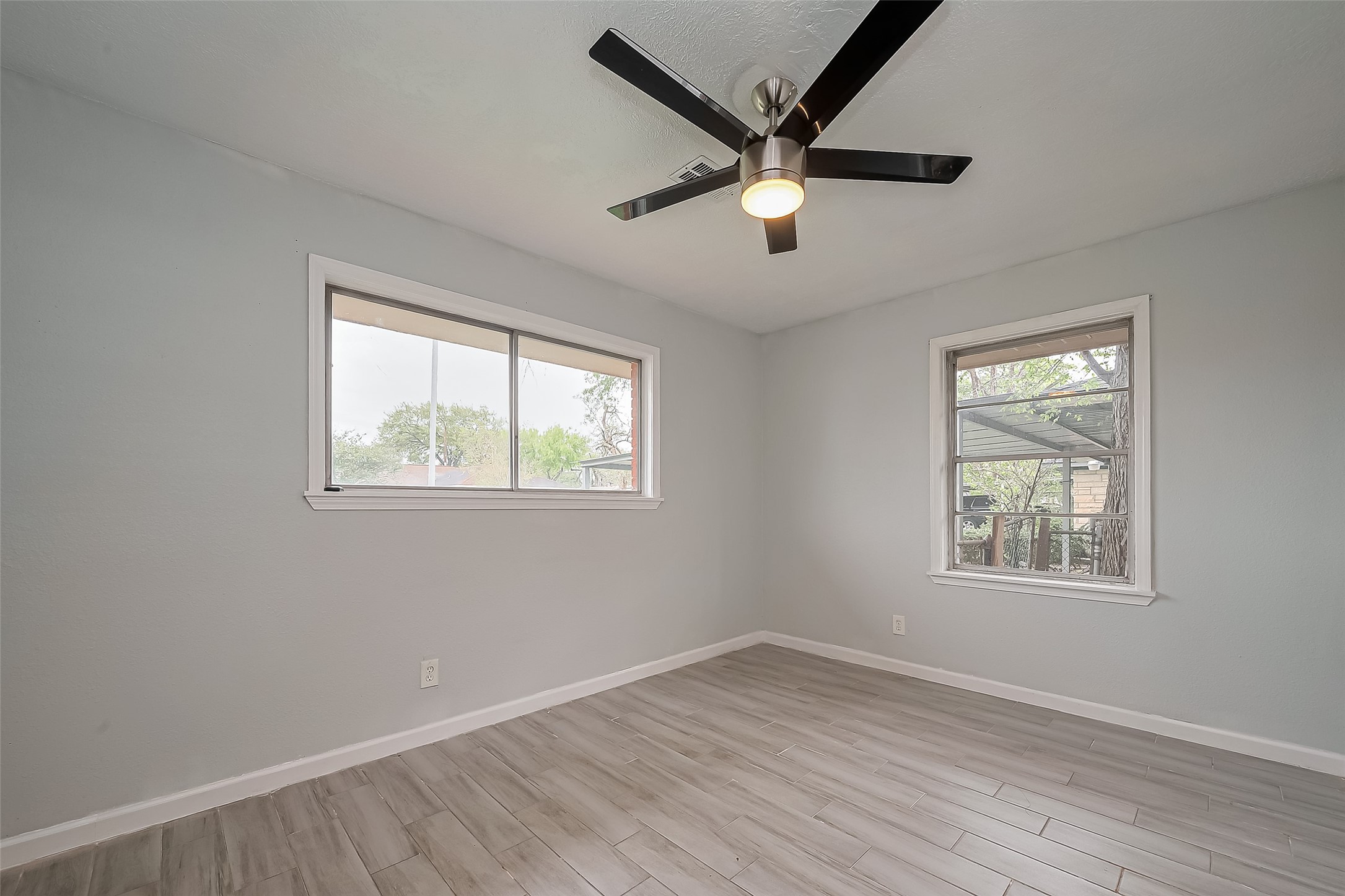 626 Shawnee Street Houston, TX 77034 - Photo 11 of 16 a view of a big room with wooden floor and windows