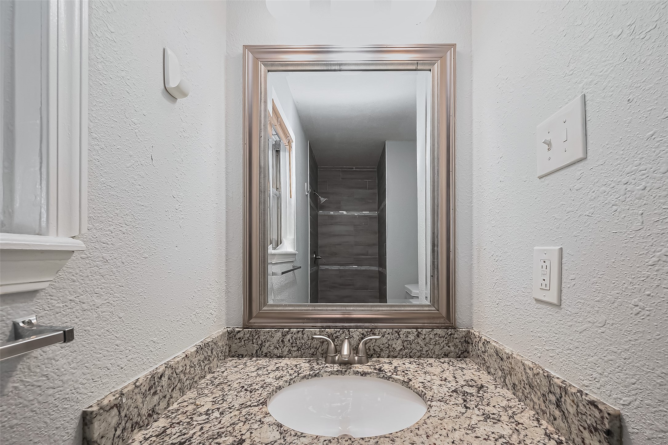 626 Shawnee Street Houston, TX 77034 - Photo 12 of 16 a bathroom with a sink and a mirror